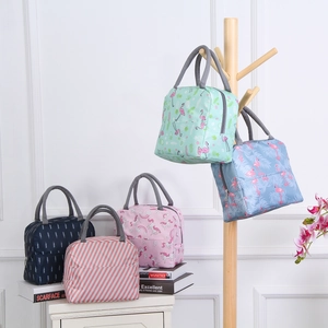 Close-up of insulated lunch bags in assorted patterns including flamingos and stripes