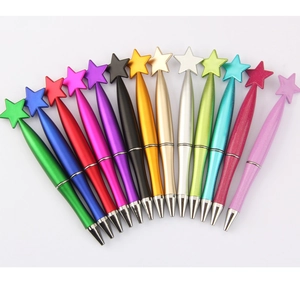 Detailed fan arrangement of thirteen colorful star-topped pens with metallic glitter finish