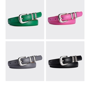 Detail view of colorful fashion belts with silver buckles in green, pink, gray and black