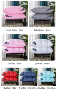 Detail of luxury hotel pillows in various colors including quilted and solid patterns
