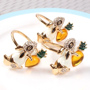 Three gold Easter bunny napkin rings with white enamel, crystals, and orange carrots