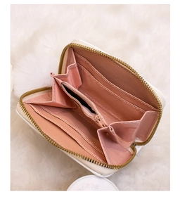 Close-up of small white plush coin purse with pink satin lining and card slots