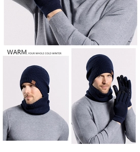 Close-up of navy knit winter set with hat, scarf, and gloves featuring mountain leather patches