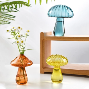 Colorful mushroom shaped glass vases for flowers and home decor in orange blue and yellow