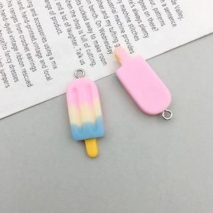 Close-up of cute resin popsicle charms in pastel gradient and pink with metal hooks