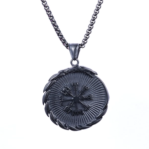 Macro view of matte black stainless steel Nordic Viking Vegvisir compass pendant necklace