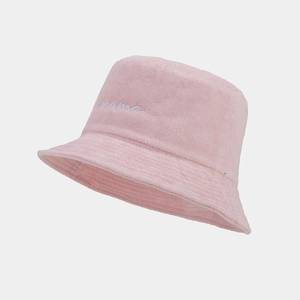 Close-up of pink terry cloth bucket hat featuring white mama script embroidery detail