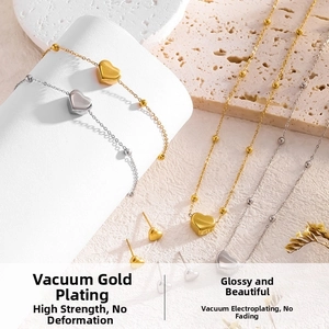 Detail of minimalist 18K gold and silver heart-shaped pendant necklaces and earrings