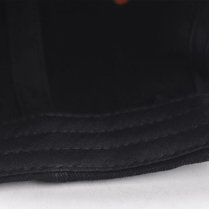 Macro detail of the interior brim stitching and premium cotton twill of the baseball cap