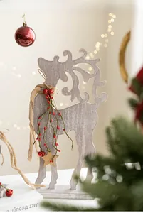 Detail of wooden Christmas reindeer decor with burlap scarf and festive berries