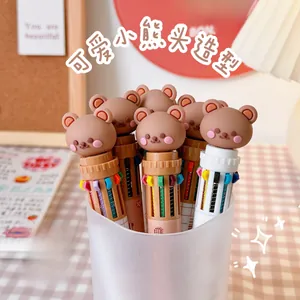 Close-up of 10-color retractable ballpoint pen featuring a 3D cartoon bear head topper
