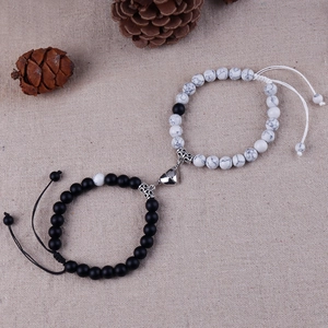 Close-up of magnetic heart-shaped clasp on marble bead bracelets for couples