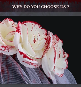 Detail of white roses with red blood splatter and mesh veil on Halloween headband
