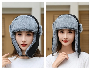 Detail of winter trapper hat showing chin strap buckle and gray faux fur lining