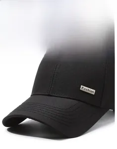 Close-up of black cotton baseball cap showing structured brim and metal Fashion logo