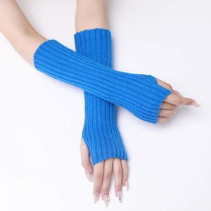 Detailed knit texture of bright blue fingerless arm warmers with thumb hole design