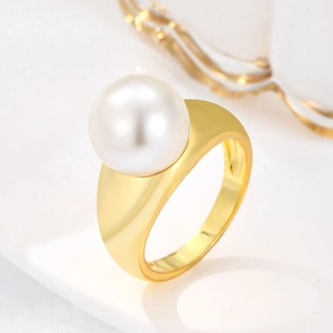 Minimalist gold ring featuring a large white round pearl with a modern brushed metal finish