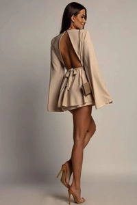 Detail of backless beige vacation dress featuring cross-tie straps and elegant flare sleeves