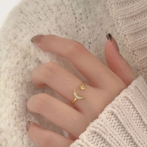 Detail of delicate moon and star open ring with micro-pave crystals on model's finger