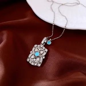 Sparkling silver flower pendant with blue stone and zircons on a luxury pearl chain