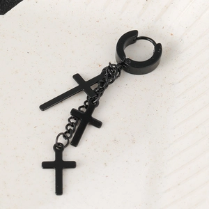 Macro shot of gothic black stainless steel hoop earrings with triple cross chain dangles