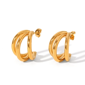 Macro detail of triple-layered golden stainless steel C-shape earrings with polished finish