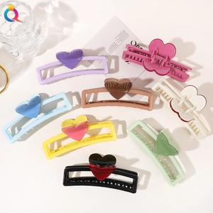 Collection of colorful heart-shaped hair claws in pastel resin finishes for hair styling