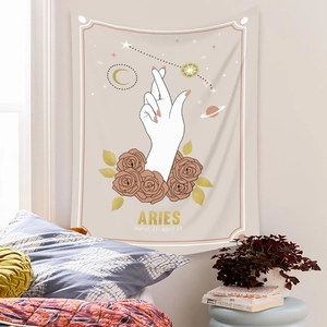 Detailed view of an Aries zodiac tapestry with rose and moon motifs on a bedroom wall