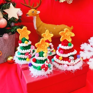 Handcrafted crochet Christmas trees with colorful pompoms and stars for pet holiday decor