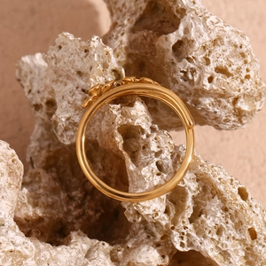 Detailed view of 18K gold plated double layer ring with three flowers on beige stone