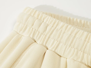 Detail of high-elasticity ribbed knit waistband on beige heavy cotton gym shorts