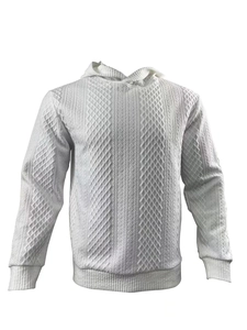 Close-up of white knitted hoodie featuring intricate diamond jacquard patterns and textures