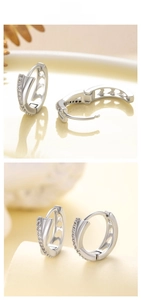 Detail of silver cross zircon hoop earrings with hollow heart design and clasp mechanism