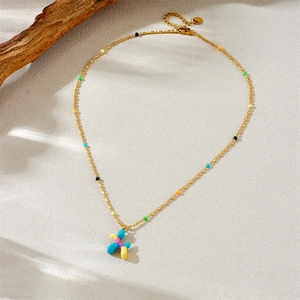 Golden stainless steel necklace featuring colorful beads and a cute balloon dog pendant