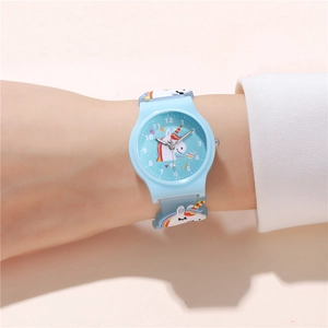 Close-up of children's blue unicorn watch with colorful patterns on a soft silicone strap