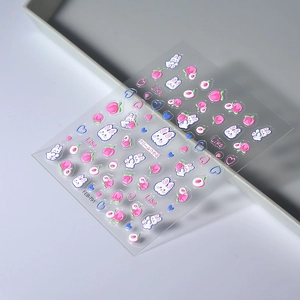 Close-up of 5D embossed nail stickers featuring cute rabbits, peaches and hearts