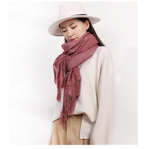 Detail view of dark red knitted scarf with fringe tassels on a fashion model
