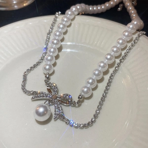 French style double-layer pearl necklace with silver rhinestone bow pendant in white tray