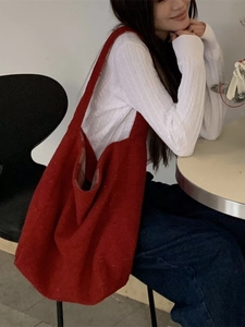 Large red wool felt tote bag for autumn commuting with plaid lining shown on shoulder