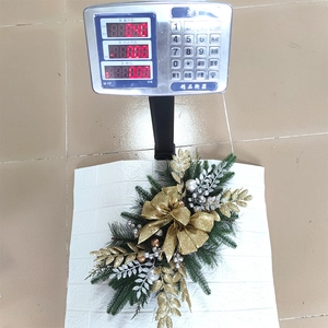 Detailed view of a 140g Christmas garland with gold bows and silver berry ornaments