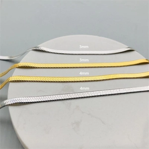 Gold and silver 3mm and 4mm herringbone snake chains on marble display stand