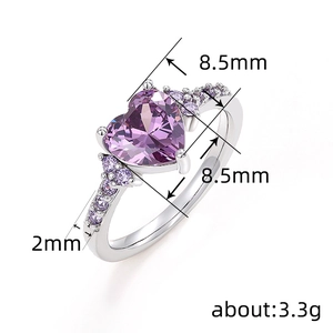 Elegant silver ring with heart-cut purple gemstone and pave-set accents on a white background