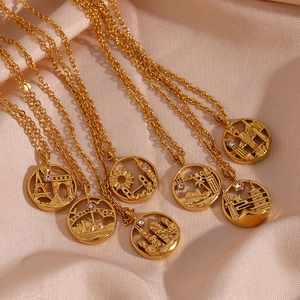 Detail of gold world city landmark pendants on luxury champagne satin fabric