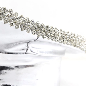 Close-up of sparkling rhinestone rows on a silver mirror-finish party captain hat