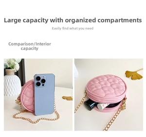 Pink quilted mini round chain bag showing interior storage for lipstick and small items