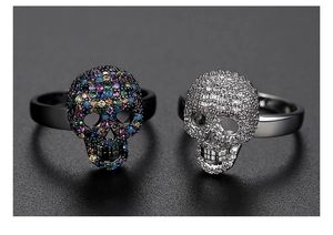 Close-up of gothic skull rings with colorful gemstones and silver cubic zirconia