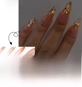 Detail of pink gradient almond press-on nails with gold glitter and aurora sequins