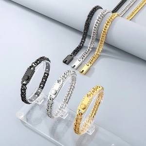 Detailed close-up of Cuban link chains in gold, silver, and black with unique buckle clasps