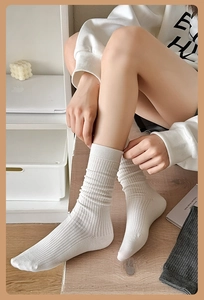 Detailed view of white ribbed crew socks with breathable cotton texture on foot