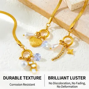 Close-up of gold-plated snake chains with heart, pearl, and crystal charms detail